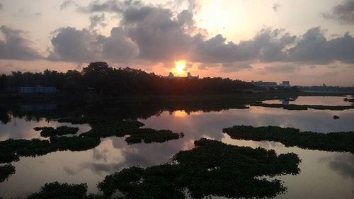 Scenic view of lake against cloudy sky