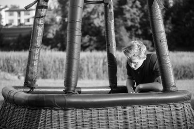 Boy looking in basket outdoors