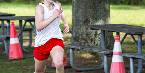 One female cross country runner finishing a 5k in sunken meadow state park.