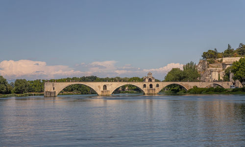 Arch bridge over river against sky