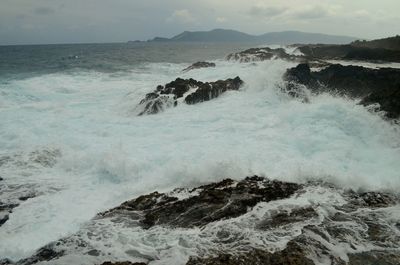 Waves breaking on coast in sea