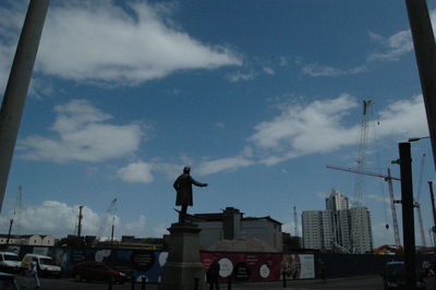 Low angle view of building against cloudy sky