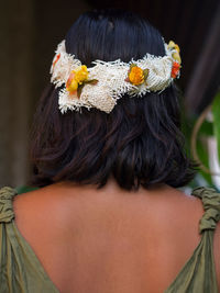 Rear view of woman with pink flower