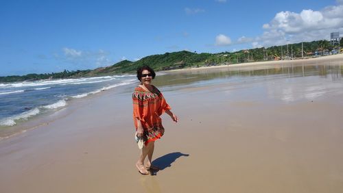 Full length of woman standing on beach