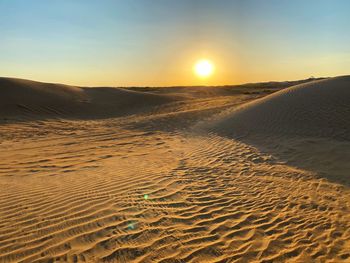 Scenic view of desert against sky during sunset
