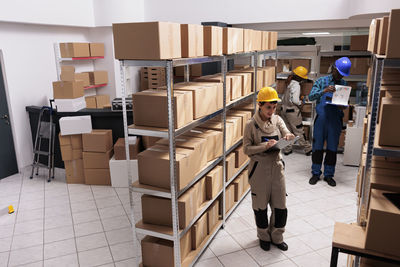 Rear view of woman standing in factory