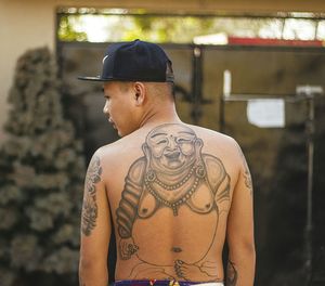 Tattoo on man back standing outdoors