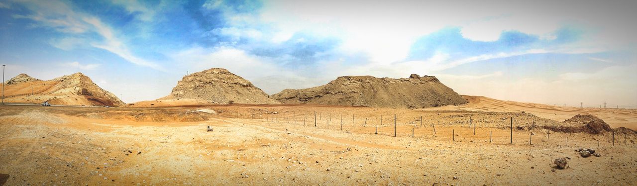 sky, mountain, tranquility, landscape, tranquil scene, cloud - sky, rock formation, scenics, cloud, nature, mountain range, rock - object, arid climate, physical geography, beauty in nature, desert, geology, famous place, non-urban scene, travel destinations