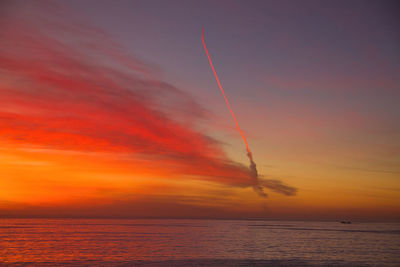 Scenic view of sea against romantic sky at sunset