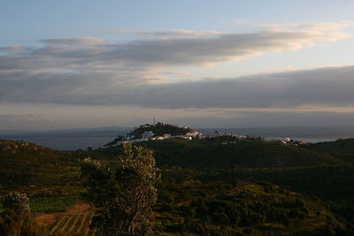 Scenic view of sea and buildings against sky during sunset