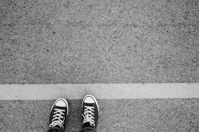 Low section of person standing on footpath