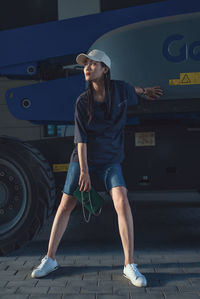 Beautiful woman wearing cap on footpath