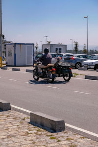 Cars on road against buildings in city