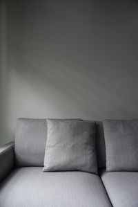 Stack of sofa against wall at home