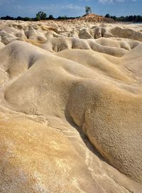 Sand dunes in desert against sky