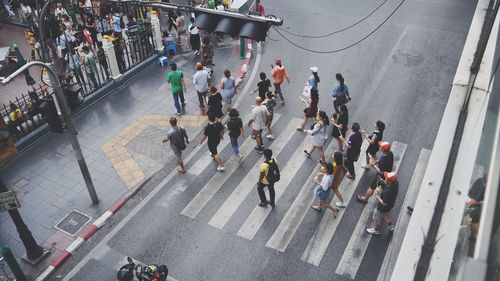 High angle view of people walking on city street