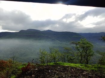 Scenic view of landscape and mountains against sky