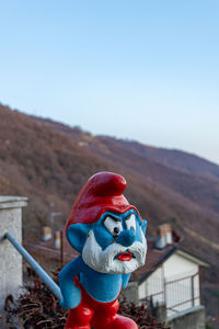 Toy sculpture against blue sky