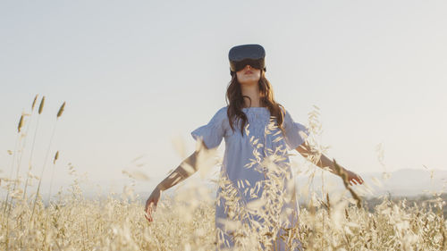 Girl with virtual reality glasses looks at the futuristic nature