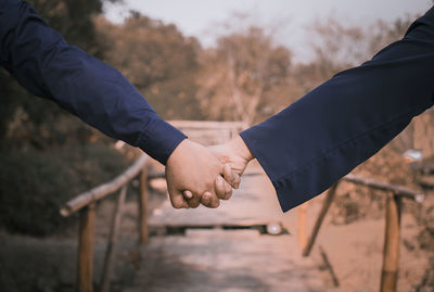 Midsection of man holding hands