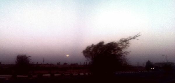 Scenic view of field against cloudy sky