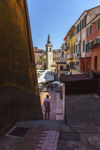 People walking on street amidst buildings in city