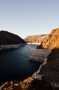 Scenic view of river and mountains against clear sky