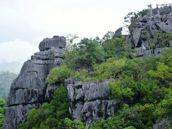 Rocks on cliff against sky
