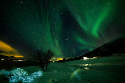 Scenic view of landscape against sky at night