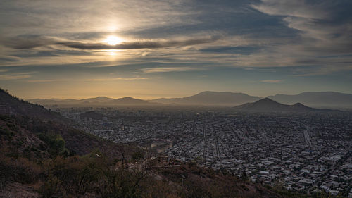 High angle view of buildings against sky during sunset