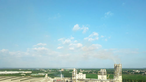 Aerial view of buildings in city against sky