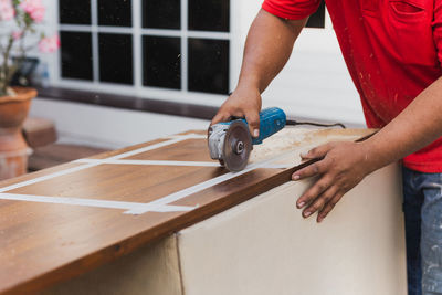 Midsection of man working in workshop