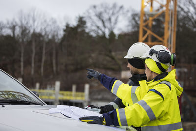 Construction engineers discussing project at construction site