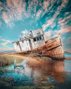 Abandoned built structure on beach against sky