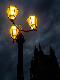 Low angle view of illuminated street light against sky at night