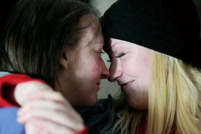 Close-up of lesbian couple romancing at home