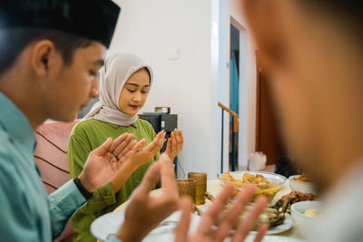 Young woman eating food at home