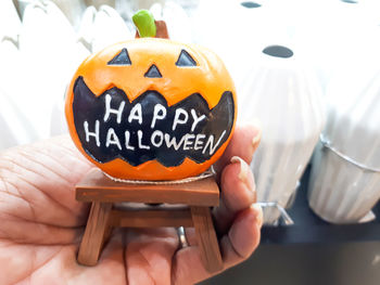 Close-up of a hand holding pumpkin