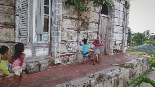 Full length of woman standing in front of building