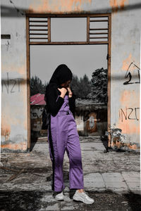 Full length of woman standing on abandoned building