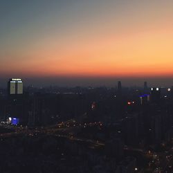 High angle view of illuminated buildings against sky at sunset