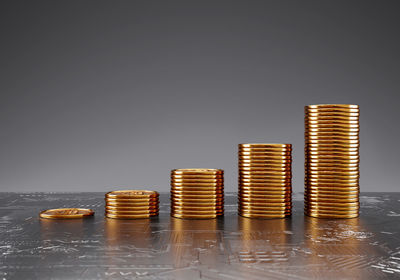 Stack of coin on table against white background