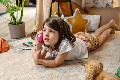High angle view of girl playing with toy