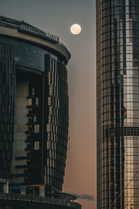 Moon rise between two buildings