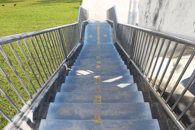 Concrete stairs of a footbridge with stainless steel handrails.