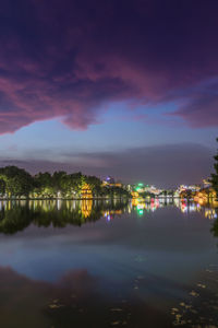 Scenic view of lake against sky at night