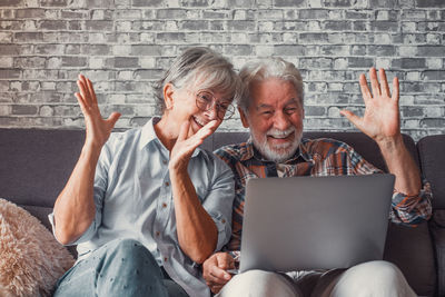 Woman using laptop while sitting at home