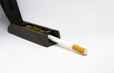 High angle view of cigarette against white background