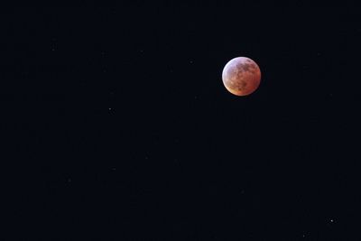 Low angle view of moon against sky at night