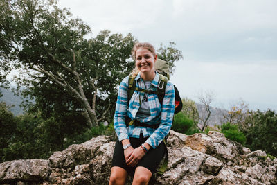 Portrait of smiling young man on rock